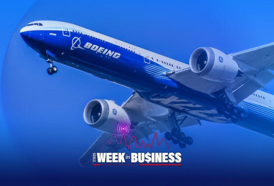 A Boeing airplane in flight with a blue sky background. Below, there is a graphic with the text "This Week in Business" featuring a city skyline, soundwaves, and a red line graph.